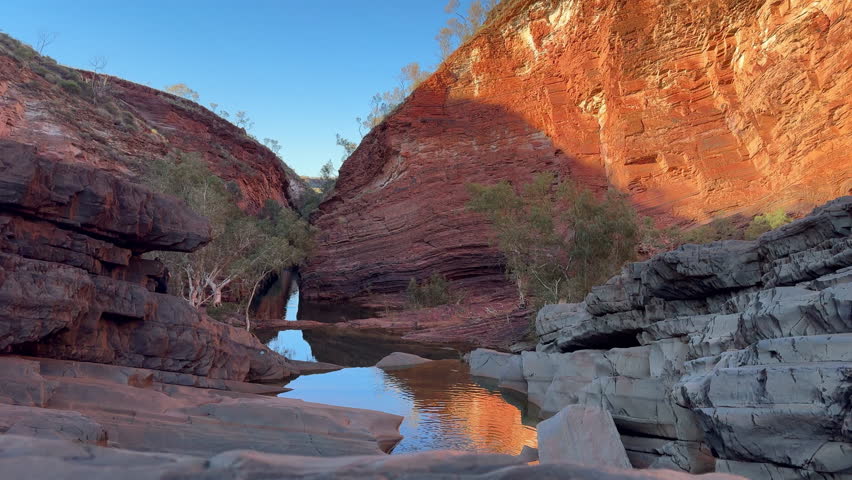 Landscape view of fresh water flowing through the iconic Hamersley Gorge at Karijini National Park Pilbara region in Western Australia.