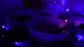 Assorted Halloween scary treats on a table, including spooky cookies, candy, decorated cupcakes and glowing festive elements, atmospheric holiday setup captured in 4K ultra HD. - Powered by Shutterstock - Get 15% off with code: PIKWIZARD15