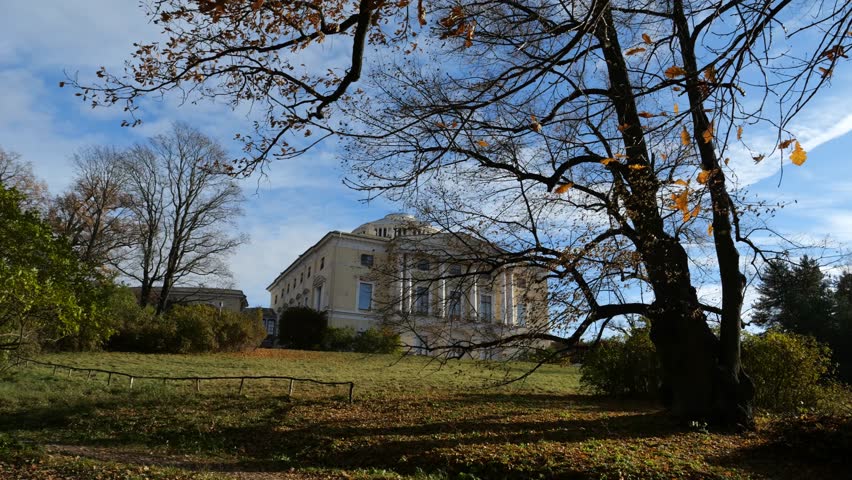 Pavlovsk Palace is visible from Slavyanka River at top of green slope, 18th-century Russian Imperial residence, suburb of St. Petersburg, Russia