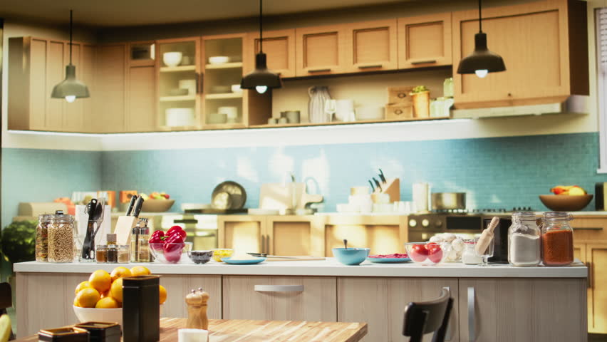 Empty kitchen island arranged with pizza essential such as flour, mozzarella, tomatoes and sauce. Baking tools and utensils line the countertop, reflecting home cooking vibe on the weekend.