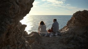 Romantic Couple Enjoys Ocean Sunset View on Rocky Cliff Vertical video - Powered by Shutterstock - Get 15% off with code: PIKWIZARD15