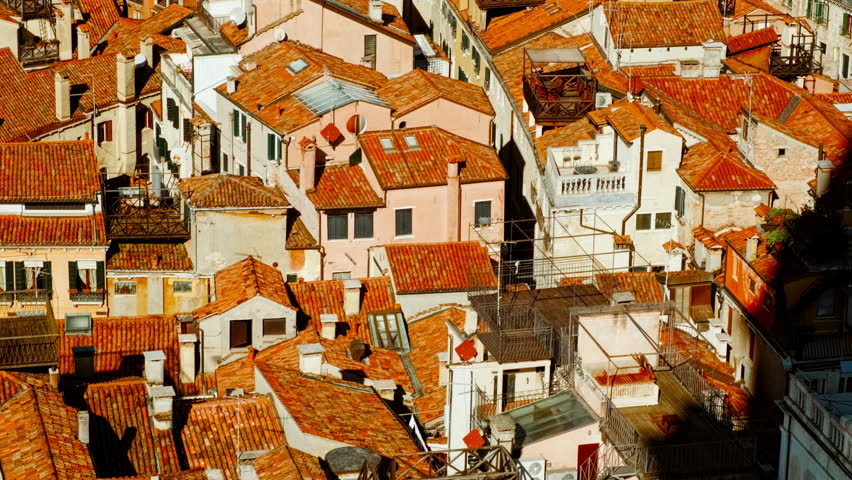 Aerial view of Venice, Veneto, Italy, revealing the lagoon city with canals, islands, church domes and red tiled roofs spreading toward the horizon

