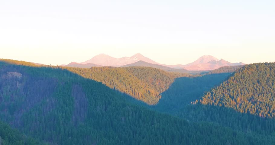 Aerial drone video of Oregon wilderness and Three Sisters during evening light