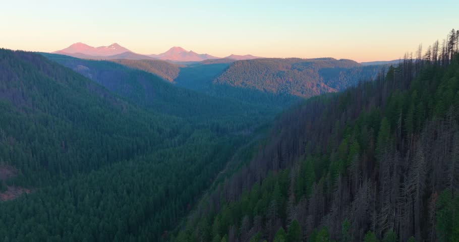 Oregon aerial drone footage showing mountain ridges and Three Sisters in the dis