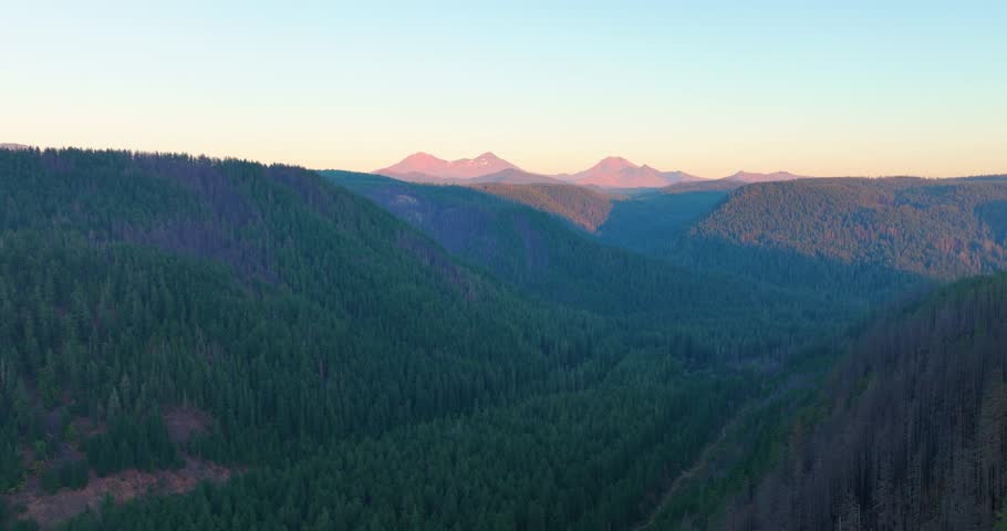 Three Sisters mountain range filmed by drone at sunset in Oregon