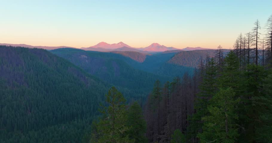 Aerial drone view of Oregon’s Three Sisters landscape illuminated by sunset