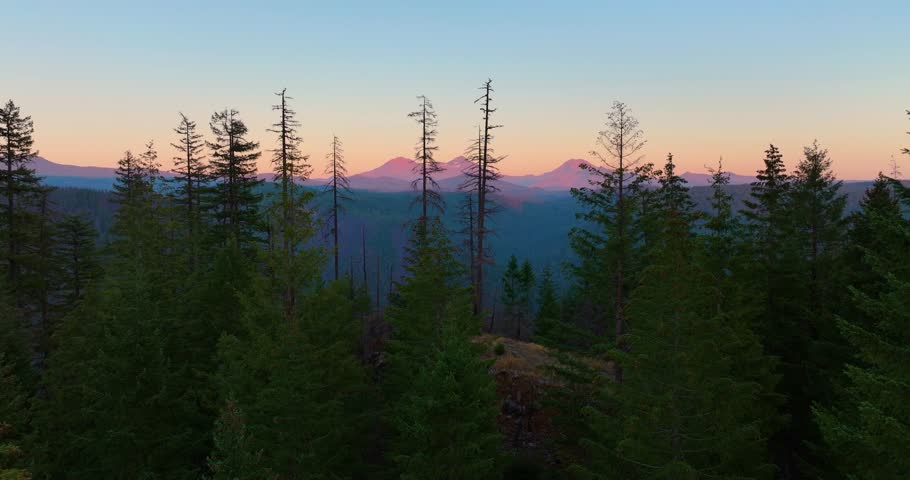 Three Sisters aerial drone shot with Oregon forest and soft sunset tones