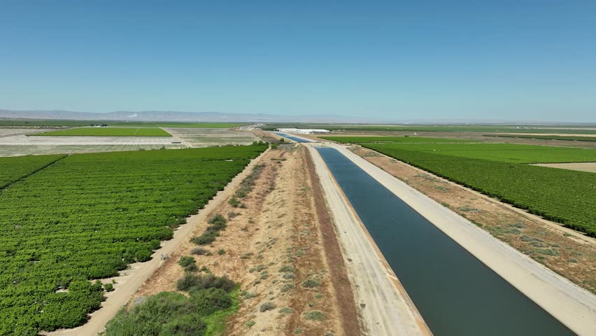 Aerial of farms along an aqueduct running through California's Central Valley north of Los Angeles.