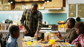 Father packing school lunch for his young son and preparing his backpack, family members enjoying breakfast together during cozy morning in the kitchen. Meal prep school bag. Camera B. - Powered by Shutterstock - Get 15% off with code: PIKWIZARD15