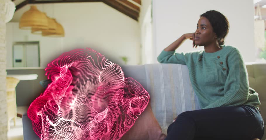 Woman seated right couch watching pink particles emerging left seat, adjusting elbow for tech demo. Livingroom, sofa, contemplative, serene, plume, crimson, glitter