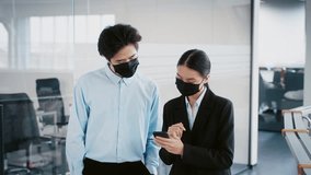 Young professionals collaborating in modern office during pandemic - Powered by Shutterstock - Get 15% off with code: PIKWIZARD15