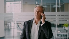 Senior businessman in office making a phone call during corporate hours - Powered by Shutterstock - Get 15% off with code: PIKWIZARD15