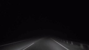 Night drive through a foggy rural road with approaching car headlights. Moody countryside atmosphere ideal for cinematic scenes or background visuals. - Powered by Shutterstock - Get 15% off with code: PIKWIZARD15