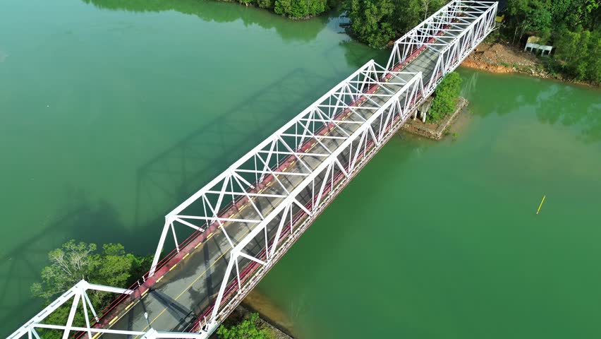 Majestic Truss Bridge Over Emerald Waters: A Breathtaking Aerial Perspective of Serene Nature