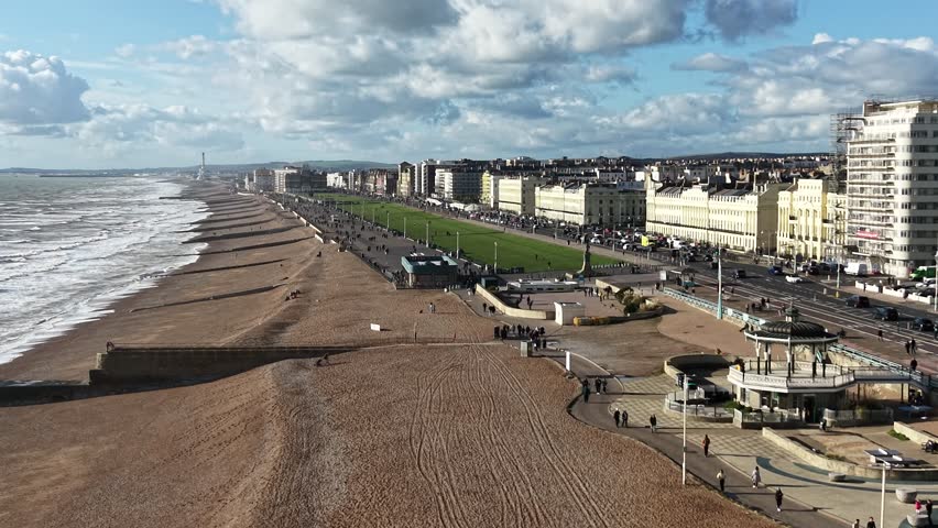 Brighton and Hove UK busy promenade drone,aerial reverse shot