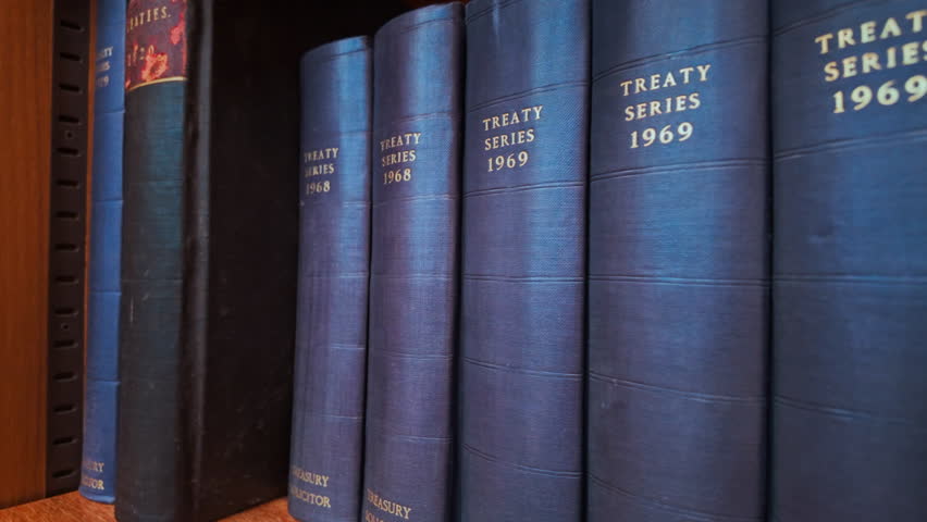 Row of Blue Law Treaty Series Books, gilt titles, cloth spines and neat alignment on a shelf
