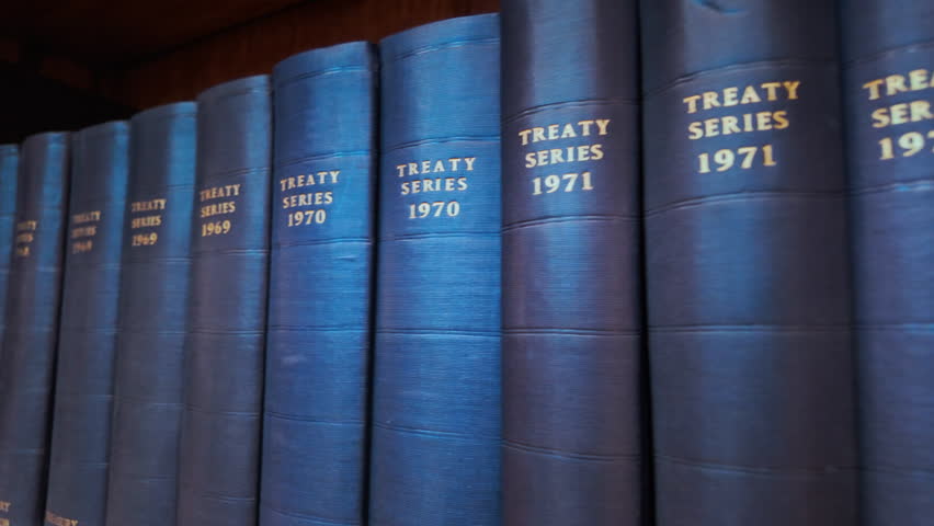 Row of Blue Law Treaty Series Books, gilt titles, cloth spines and neat alignment on a shelf
