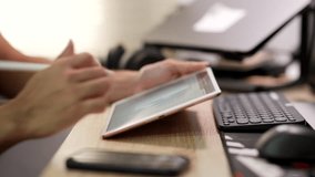 A person uses a stylus to analyze data charts on a digital tablet beside a keyboard and smartphone in an office setting. - Powered by Shutterstock - Get 15% off with code: PIKWIZARD15