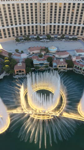 Las Vegas 10.24.2024. Stunning aerial sunset scene of Bellagio fountains show in Las Vegas. warm evening light reflects on hotel facade and water surface, beauty and energy of this iconic landmark.