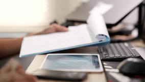 Digital data entry process showing a person using a stylus on a tablet while checking documents and typing on a computer keyboard in a modern office environment for productivity and organization. - Powered by Shutterstock - Get 15% off with code: PIKWIZARD15