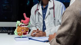 Female doctor explaining digestive system anatomy and diagnosis using intestinal model. - Powered by Shutterstock - Get 15% off with code: PIKWIZARD15