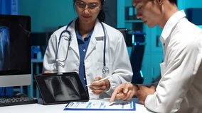 female doctor consulting with patient concerned and showing chest X-ray on digital tablet during health checkup in hospital office. - Powered by Shutterstock - Get 15% off with code: PIKWIZARD15