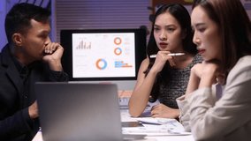 Business team discussing financial report late at night. Business team analyzing financial data on a laptop, engaging in a discussion about market trends and company performance in office. - Powered by Shutterstock - Get 15% off with code: PIKWIZARD15
