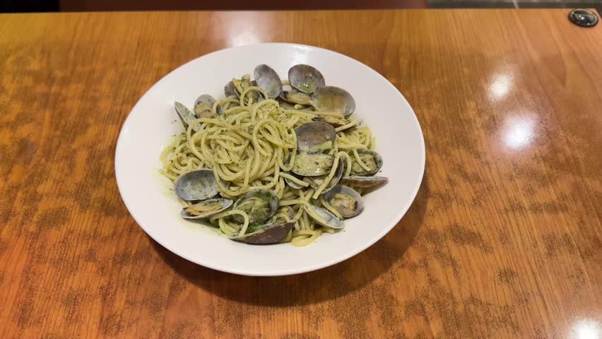 Italian seafood pasta with spaghetti and clams, lifted with a fork