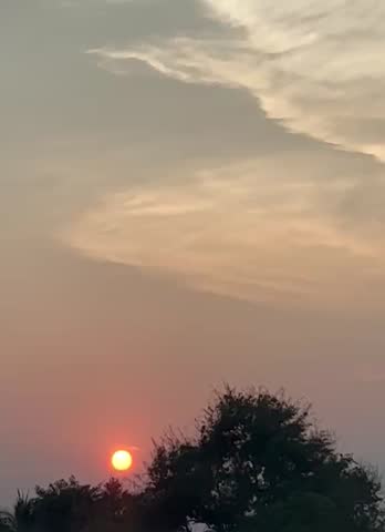 sunset over the tree and a clouds
