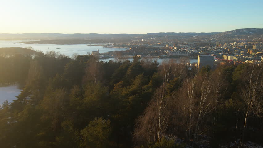 Panoramic drone shot of Oslo, Norway looking down to downtown and the city center on a bright sunny day