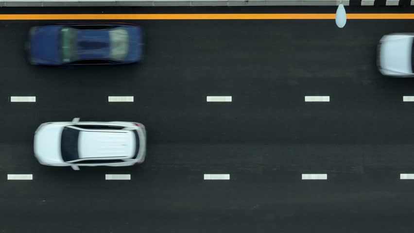 Drone view of a car on a newly constructed asphalt road, emphasizing progress in transportation, enhanced mobility, and infrastructure investment driving economic growth and safer journeys.
