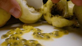 Close Hands Breaking Yellow Passion Fruit with Juicy Seeds Flowing on Plate in Slow Motion from Close Up Angle, Exotic Fruit Dessert Concept. - Powered by Shutterstock - Get 15% off with code: PIKWIZARD15