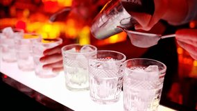 Barman making cocktails with whiskey at a bar at night, illuminated by red neon lights, capturing nightlife, mixology, and beverage preparation. - Powered by Shutterstock - Get 15% off with code: PIKWIZARD15