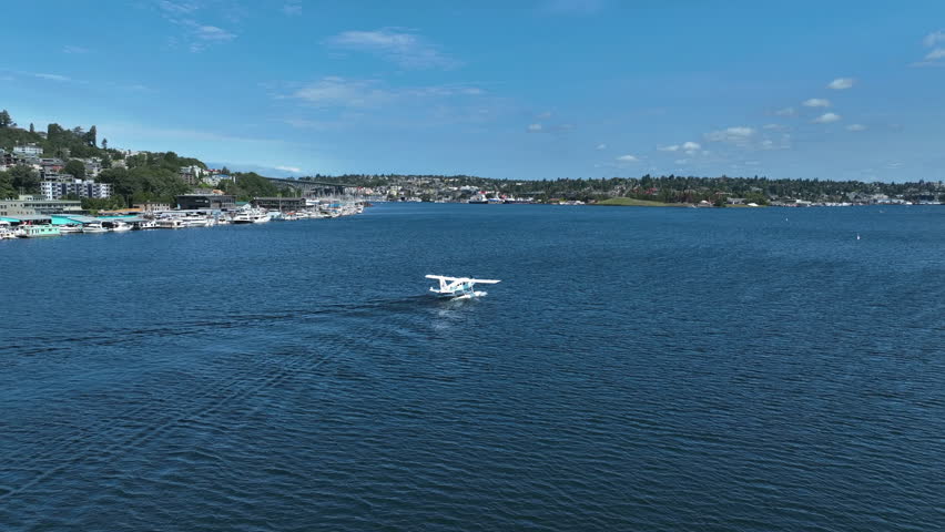 Drone shot tracking a seaplane floating on a lake, sunny, summer day in USA