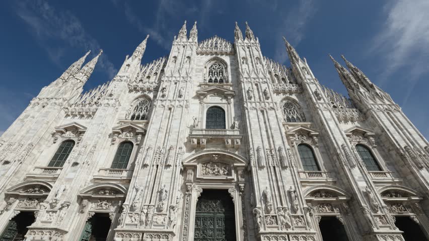 Moving towards front side of Milan Cathedral, camera tilts up