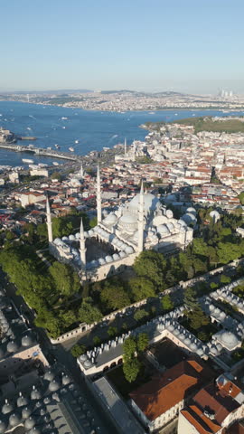 Vertical drone shot rotating away from the Suleymaniye Mosque, in sunny Istanbul