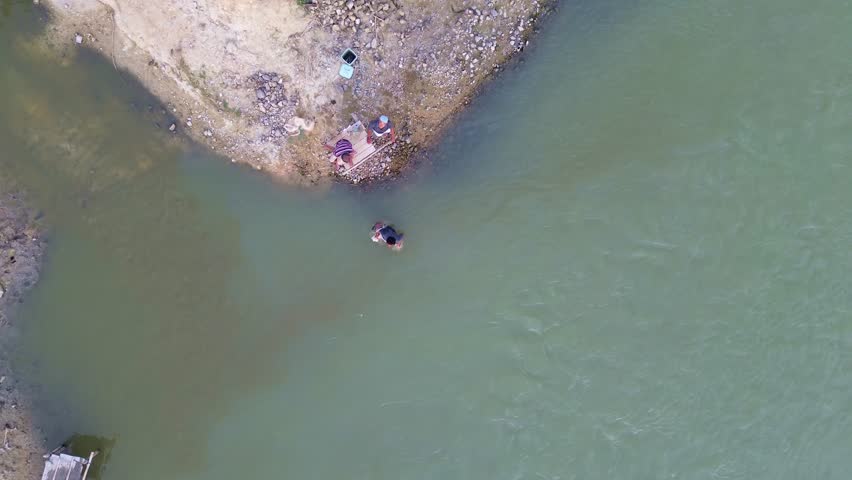 Aerial View of Fisherman Casting Net on Lake