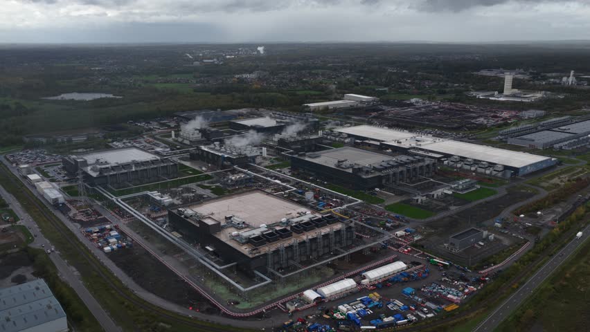 Big data, computings centers, data center, datacenter in Belgium. The Development of AI, artificial intelligience. Large complex, expansion under construction. Aerial drone video cloudy day.