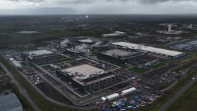 Big data, computings centers, data center, datacenter in Belgium. The Development of AI, artificial intelligience. Large complex, expansion under construction. Aerial drone video cloudy day. - Powered by Shutterstock - Get 15% off with code: PIKWIZARD15