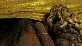 Vintage Hindu Elephant God Sculpture with Ornate Details and Gold Decorative Backdrop - Powered by Shutterstock - Get 15% off with code: PIKWIZARD15