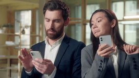 Multiethnic business colleagues using devices at office Korean businesswoman scrolling mobile phone thoughtful envious glancing coworker screen Caucasian man checks online networking browsing internet - Powered by Shutterstock - Get 15% off with code: PIKWIZARD15