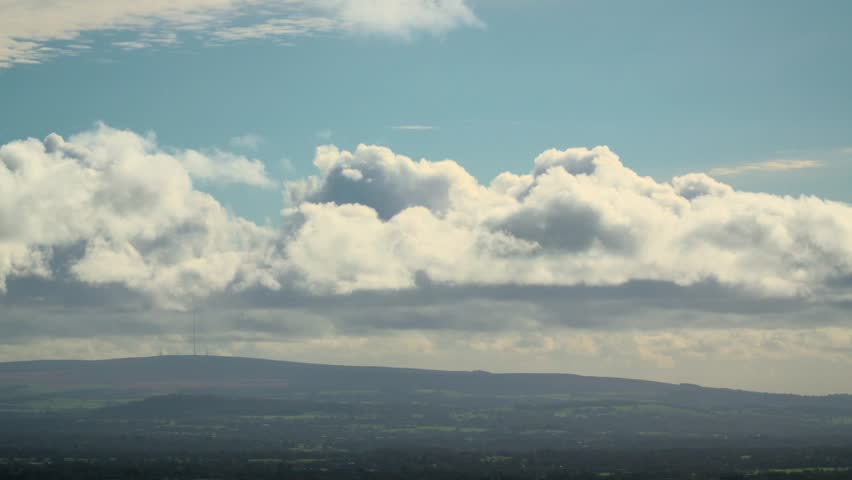 Cumulonimbus And Nimbus Clouds Gathering Over Low Hills Of English Countryside. Time Lapse 60x Normal Speed.