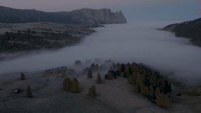 Cinematic aerial view of Sassolungo massif rising above a sea of clouds at sunrise, serene Alpe di Siusi alpine landscape in the Dolomites, Italian Alps travel destination - Powered by Shutterstock - Get 15% off with code: PIKWIZARD15