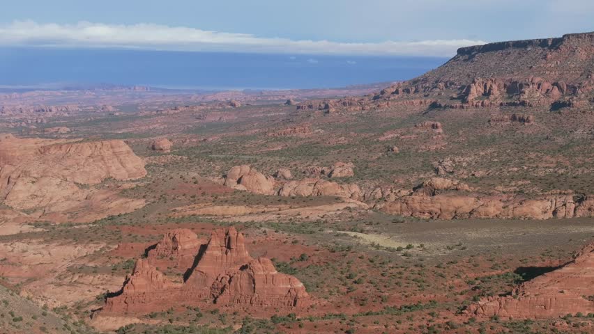 Scenic view of red rock formations under a vast sky in Moab, Utah