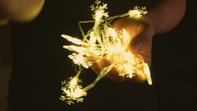 Hands gently holding glowing christmas snowflake christmas lights in a dark warm atmosphere.
 - Powered by Shutterstock - Get 15% off with code: PIKWIZARD15