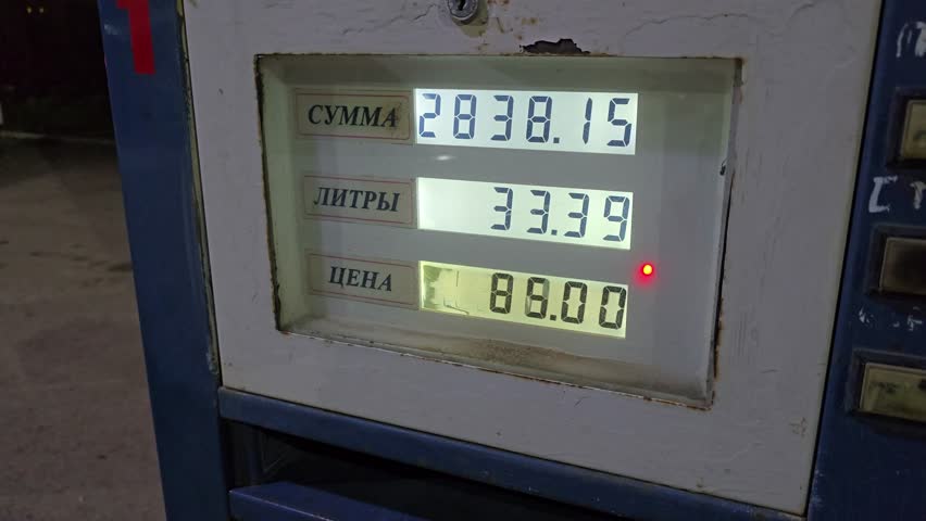 Gas filling station with an electronic display. The screen displays the volume and cost of the filled gas. Gas shortage in Kazakhstan. In Russian it is written: amount, liters, price.
