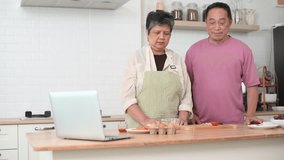 Happy Asian senior couple cooking together in kitchen, Making eggs for breakfast - Powered by Shutterstock - Get 15% off with code: PIKWIZARD15