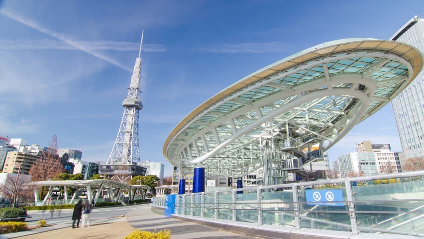 timelapse view of Nagoya TV tower at public park, a tourist attraction landmark of Nagoya city in Sakae area in sunny daytime with crowded of people around the park