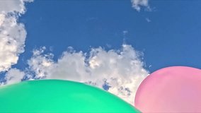 Soft colorful balloons float slowly under white clouds in a bright blue sky, creating a calm, uplifting scene symbolizing peaceful optimism and lightness. - Powered by Shutterstock - Get 15% off with code: PIKWIZARD15