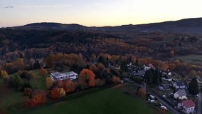 sunset over rural town, nighttime scene showcasing peaceful municipality and surrounding hills - Powered by Shutterstock - Get 15% off with code: PIKWIZARD15